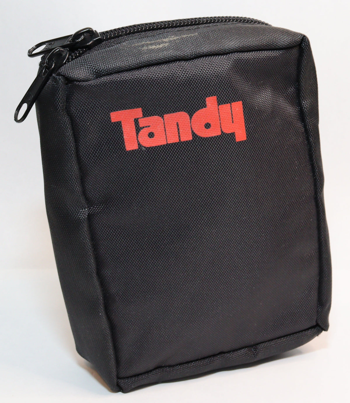 A black zippered fabric pouch with the brand name 'Tandy' printed in red across the front, photographed on a white studio background.