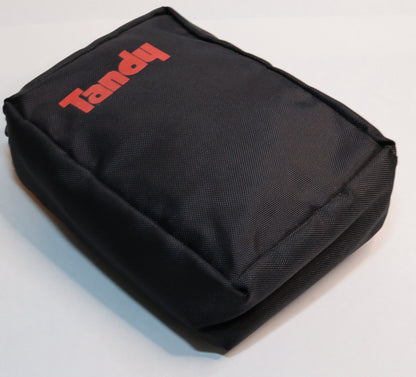 A black fabric pouch with the brand name 'Tandy' printed in red on the front, photographed on a white surface.